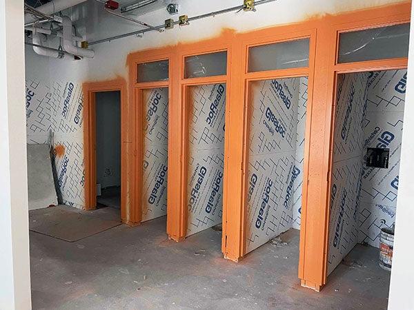 small rooms under construction with painted door frames